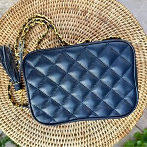 Bloomingdale's leather camera bag with leather chain. Gold hardware, zip close.